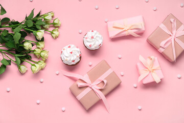 Tasty cupcakes, presents and roses on pink background