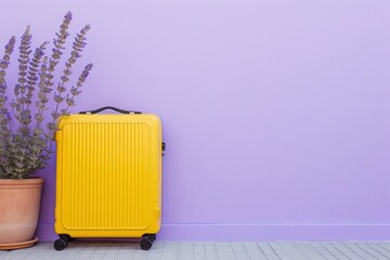 a yellow suitcase is leaning against a purple wall next to a potted plant