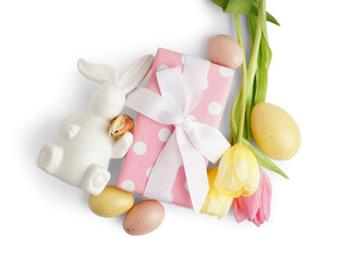 Easter bunny figure, painted eggs, tulips and gift on white background