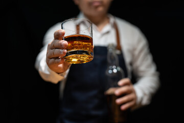 Barman pouring whiskey whiskey glass..