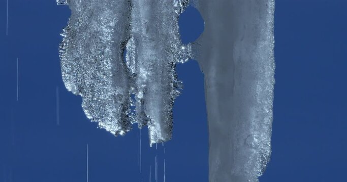 Melting icicles isolated against blue sky
