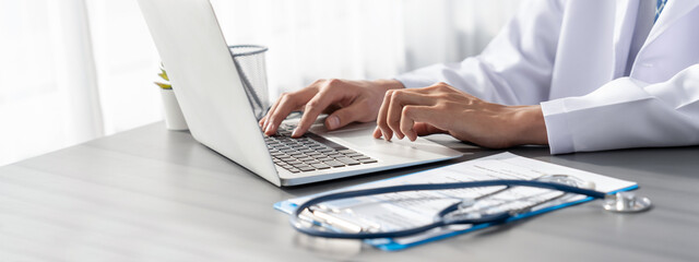 Doctor carefully review detailed medical report with laptop and diagnosing illness for effective...