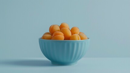 A bowl filled with sweet apricot  on a simple white background