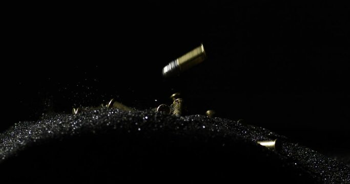 .22 Long Rifle Bullets Slowly Landing Over Smokeless Powder. Slow Motion Shot