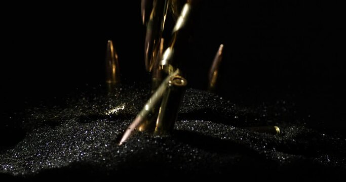 Many 7.62×35mm Intermediate Cartridge Falling On Gunpowder. Slow Motion Shot
