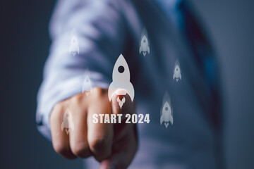 Businessman pointing rocket icon new business start up 2024. Growing to target.