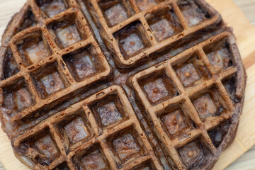 Dessert waffles placed on a wooden table surface