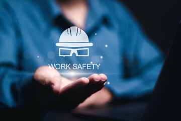 Work safety concept. regulations and standard in industry. Person holding safety icon on virtual screen for working standard process and zero accidents.