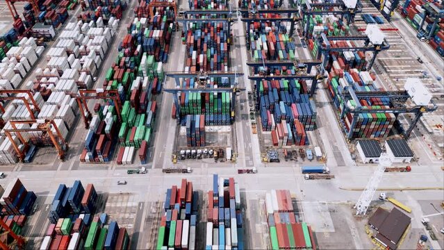 Supply Boxes Loading at Industrial Dockyard. Cargo Shipping Port and Transportation Containers of Freight Concept. Flight Top Panorama of Stacking Shipment in Working Wharf Hong Kong 4k