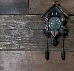 old clock on wooden wall