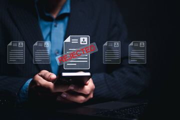REJECTED Job Application document. Businessman use smartphone and laptop with personal information...