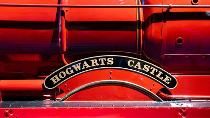 Fototapeta premium JAPAN - NOV 13, 2023: Hogwarts Castle destination signage logo from side of red railway express in Warner Bros. Studio Tour Tokyo Japan, The Making of Harry Potter