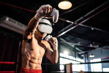 Asian sportsman using innovative technology VR glasses for exercise. 