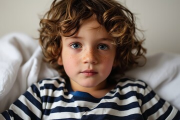 Portrait of a cute little boy with freckles on his face