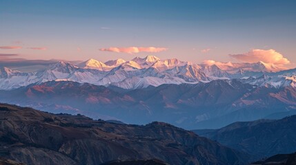 Golden hour brilliance on snow-capped mountains, a breathtaking panorama