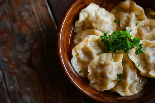 Damplings served with a parsley on a wooden table. Top view with copy space. Traditional food concept