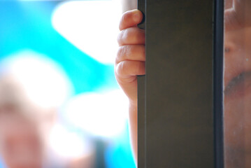 Close-up shot capturing the essence of infantile curiosity. The tiny knuckles of a child's hand,...