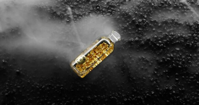 Bottle of 24k Gold bottle on black rock background is surrounded by a milky white haze