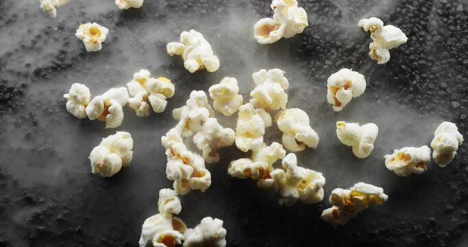 Fresh butter popcorn sits on a bed of smokin hot black rocks