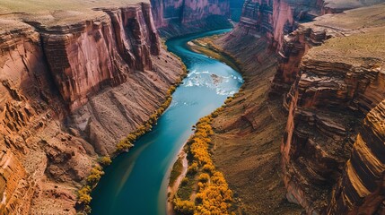 Bird’s Eye View of a Calm River Meandering Through Sun-Kissed Rocky Canyons