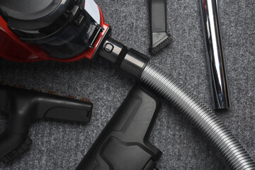 Vacuum cleaner with attachments on carpet