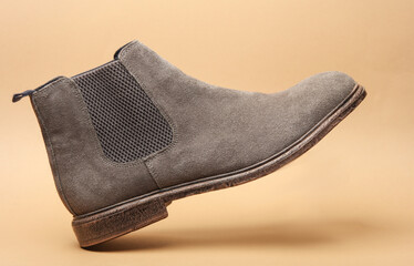Chelsea boot floating on beige background