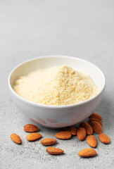 Fresh almond flour in a  bowl and almonds