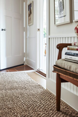 Intimate interior design composition with a classic wooden chair and a textured carpet