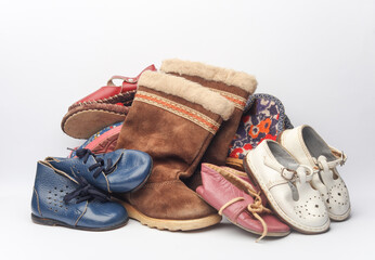 Stack of children's shoes on white background