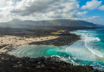 Landscape with turquoise ocean water on Caleta del Mojon Blanco in Lanzarote, Canary Islands, Spain