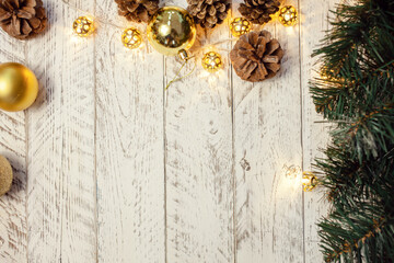 White wooden Christmas background. Empty space for text. Happy New Year. Cones, spruce branch, garland