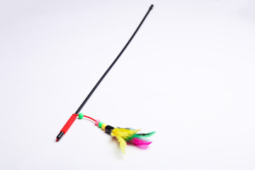 Stick with feathers on a white background. Cat toy