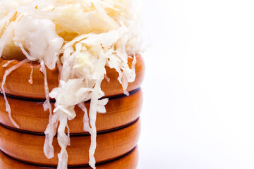 sauerkraut in a wooden barrel on a white background