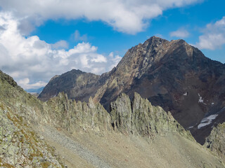 Unique rock formations with panoramic view of the majestic mountain ridges of High Tauern seen near Gloedis in Schober group, East Tyrol, Austria, EU. Idyllic high alpine landscape in Austrian Alps