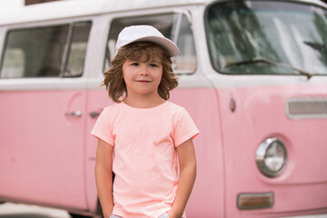 Lifestyle closeup portrait of funny kids face outdoors. Summer kid outdoor portrait. Close up face of cute child. Kid having fun outdoor on sunny summer day.