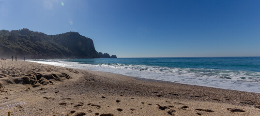 Panoramic view of the coastline of a beach on the Mediterranean coast in Alanya city in calm sunny weather in February.