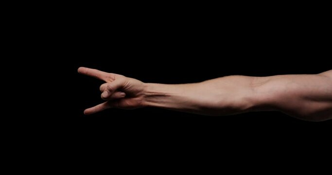 Hand gestures with alpha channel. Pre keyed. Muscular male arm shows mano cornuta metal hand gesture