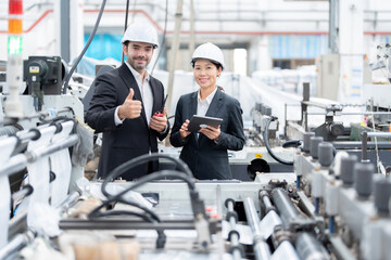 senior official Asian woman and European male architectural engineer thumbs up like symbol Work in...