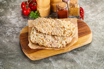 Breaded raw breaded meat schnitzel