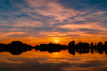 Sunset with reflections near Plattling, Isar, Bavaria, Germany