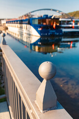 Summer view with details of a bridge railing and reflections at Vilshofen, Danube, Bavaria, Germany