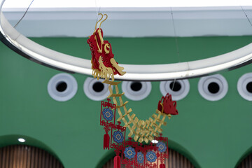 Chinese dragon in front of a shop window, closeup of photo

