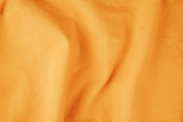 Yellow denim folds close-up, seams on a yellow denim jacket close-up.