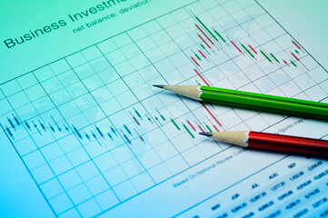 Pencil on stock market graph, Business investment concept