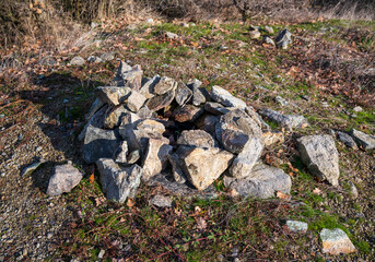 A pile of stones in grass and moss.