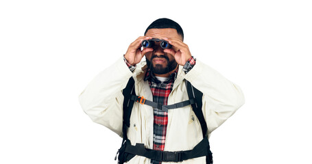 Man, binoculars or search on hiking with backpack for travel, sightseeing and adventure on holiday or vacation. Tourist, guy or safari with birdwatching or trip isolated on png transparent background © Shrikant/peopleimages.com