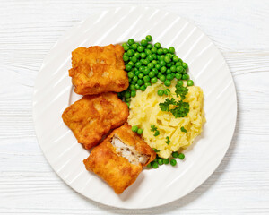 fried fish with mashed potatoes and green peas