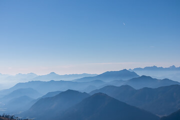 Obraz premium Panoramic view of magical mountain peaks of Karawanks and Julian Alps seen from Goldeck, Latschur group, Gailtal Alps, Carinthia, Austria, EU. Mystical atmosphere in Austrian Alps on sunny summer day.