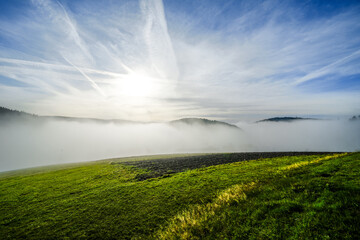 Landscape with fog in the Black Forest. Nature in the morning with meadows and hills.
