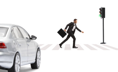 Full length profile shot of a businessman with a briefcase running in front of a car